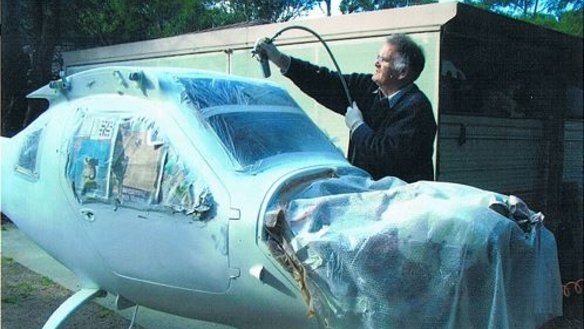 Robin works on his plane in the backyard.