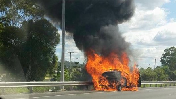 A car exploded in flames beside the Pacific Motorway on the Gold Coast on Wednesday morning.