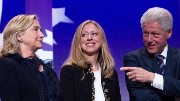 Former US president Bill Clinton on stage with his wife Hillary Rodham Clinton, former US Secretary of State, and their daughter Chelsea Clinton in 2011.