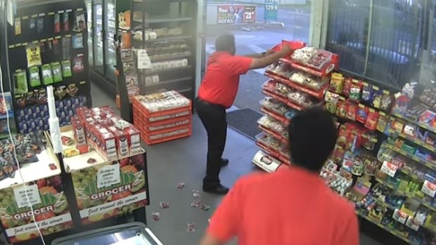 Service station attendant throws bags of lollies to stop an aborted robbery.