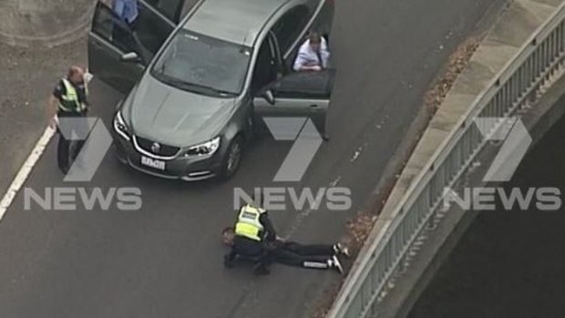 A man is arrested at the Eastern Freeway-Burke Road interchange.