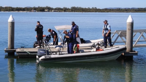 Police search for the body of William Lam at Wallis Lake on the NSW mid-north coast.