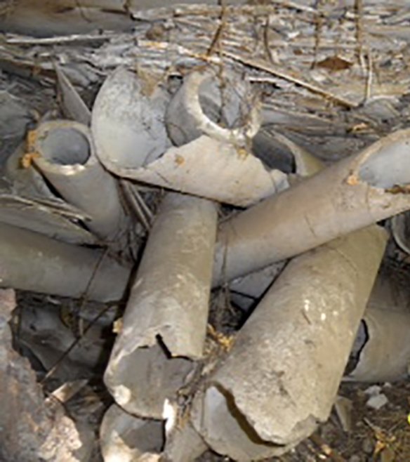 Broken pieces of asbestos left on an embankment Broken pieces of asbestos above A'Becketts Creek in Granville, behind Sam Mitry's home.