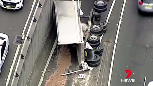 The truck, which was carrying soil, overturned on the Cahill Expressway.