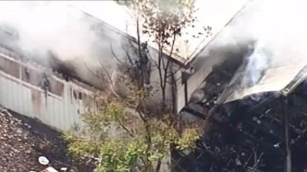 Firefighters battle a blaze at a home in Brisbane's west on Sunday.
