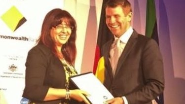 Eman Sharobeem receives her commendation in the Australian of the Year Award in November 2014 from then-NSW premier Mike Baird.