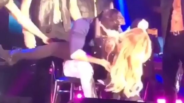 Touch my body ... Mariah Carey shares an awkward moment on the lap of choreographer Bryan Tanaka during a show in South Africa.