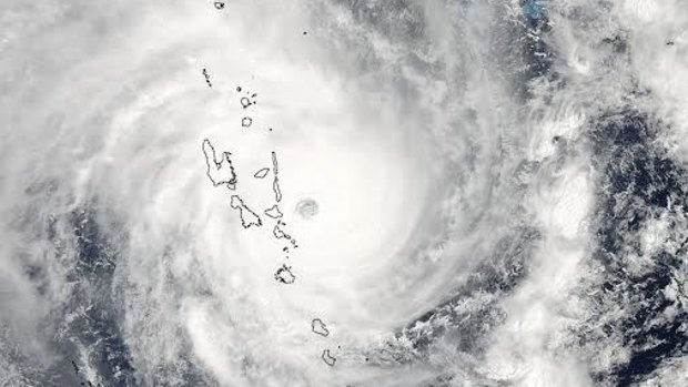 A satellite image obtained from NASA shows Tropical Cyclone Pam hitting Vanuatu on Friday. Pam triggered flooding along with evacuation orders affecting thousands of people in Vanuatu.