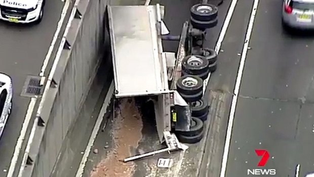 The truck, which was carrying soil, overturned on the Cahill Expressway.