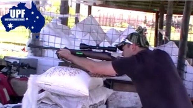 A still from a video showing former UPF organiser Shermon Burgess shooting a rifle.  