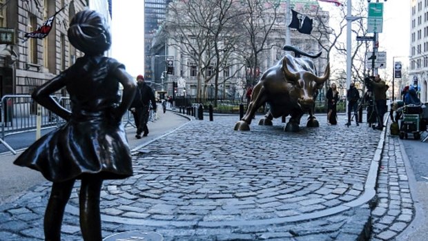 The Fearless Girl stands across from Wall Street's famous Charging Bull.