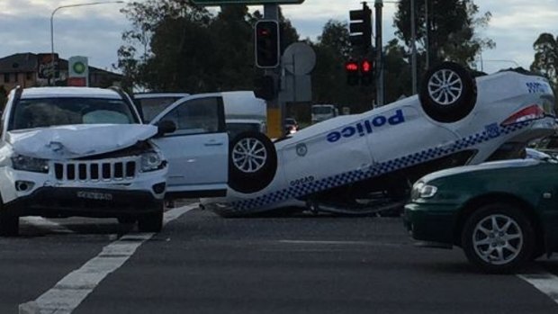 A police car has flipped in Hinchinbrook in south-west Sydney.