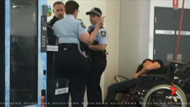 High drama: This photo reportedly shows Grant Hackett slumped in a wheelchair after being removed from the plane.