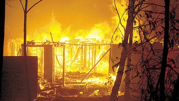 A house burns after being engulfed by a bushfire in the Canberra suburb of Duffy January 18, 2003.
