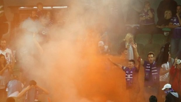 Frustration: Perth Glory fans set off flares during Friday night's loss to the Sky Blues.