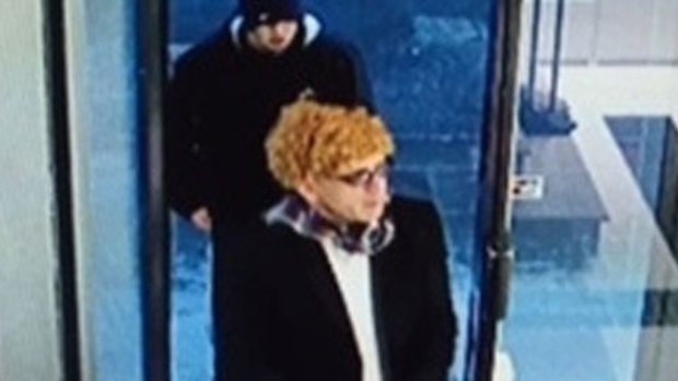 One of the thieves donned an orange wig.