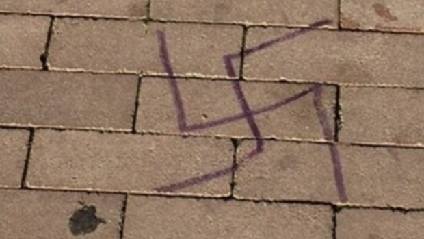 A Bondi Beach pavement defaced with a swastika symbol.