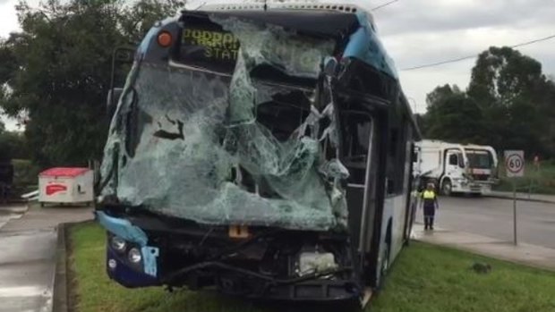 The front of the bus was seriously damaged when it collided with a garbage truck.