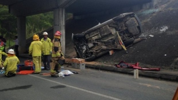 Emergency workers at the scene of a crash off teh Bruce Highway at Palmwoods.