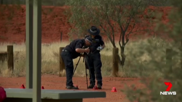 Police investigate at the scene of a stabbing death in the Northern Territory. 