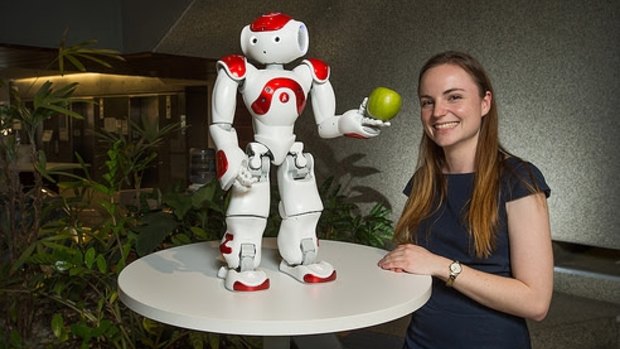 Nicole Robinson with one of the NAO robots.