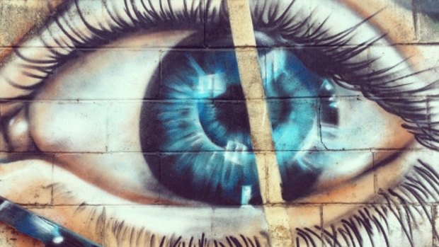 Street art eye staring out at Ainslie alleyway. 