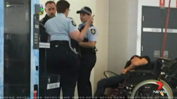 High drama: This photo reportedly shows Grant Hackett slumped in a wheelchair after being removed from the plane.