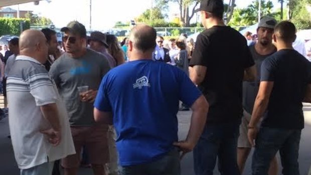 Kieran Foran, in blue T-shirt, cap and sunglasses, directly in front of Eddie Hasyon, at the Gosford Races on Anzac Day this year.