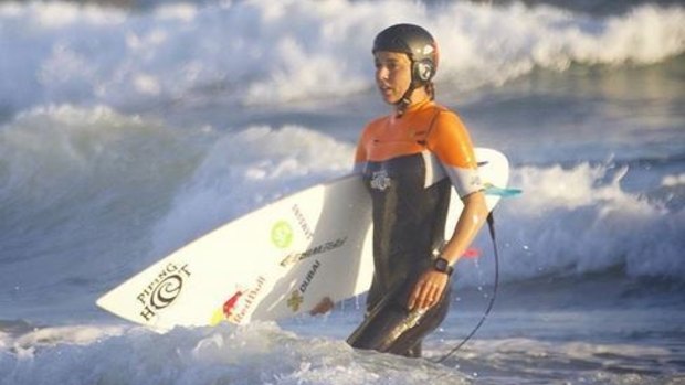 Helmeted: Sally Fitzgibbons emerges from the surf at the US Open.