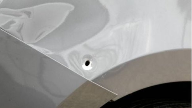 A bullet hole in the car.