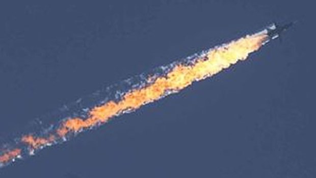 The Russian Su-24 on fire after being shot down by Turkish F-16s. 