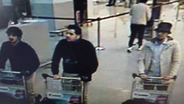 Nam Laachraoui, left captured on CCTV, moments before the blast with two other bombers. 