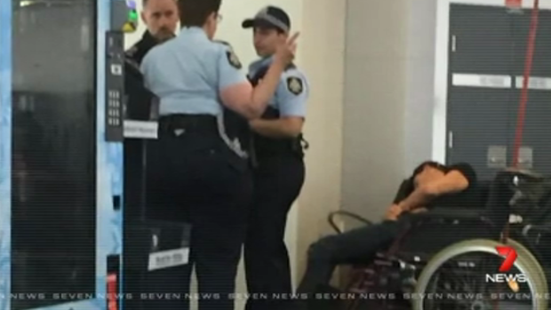 High drama: This photo reportedly shows Grant Hackett slumped in a wheelchair after being removed from the plane.