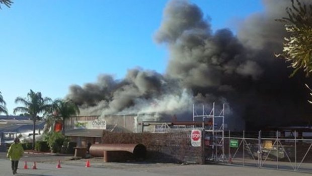 The factory engulfed in flames. 