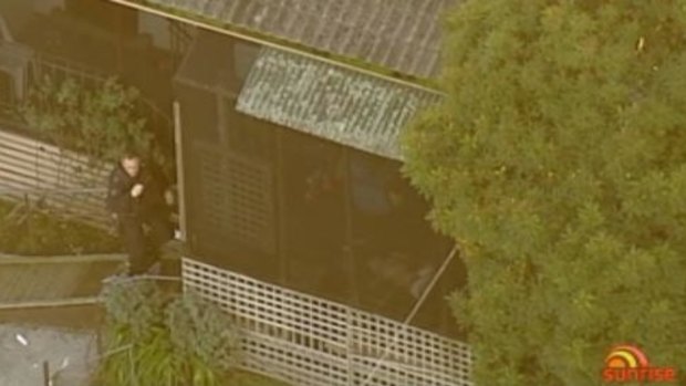 A police officer outside the Doveton property.