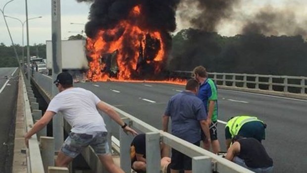 Black smoke billows from a truck that caught fire after jackknifing on the M1 at Nerang on Tuesday.