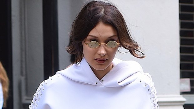 Bella Hadid doing her bit to make tiny glasses happen. 