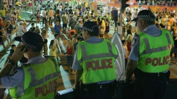 Police officers watch over the Schoolies week celebrations in Surfers Paradise.