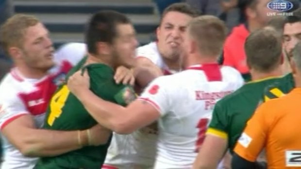 Biff is back: Sam Burgess punches David Klemmer in their Four Nations clash.