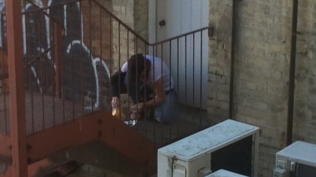 A drug user injects on the fire escape at The George. 