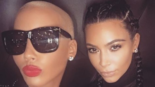 Keeping enemies closer: Kim Kardashian poses with Kanye West's estranged ex Amber Rose after last week's Twitter feud. 