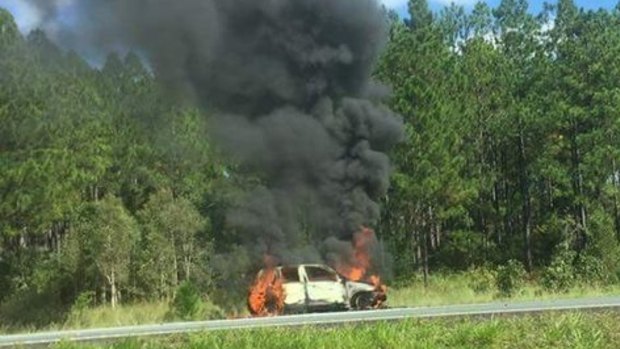 A car on fire on the Bruce Highway at Glasshouse Mountains.