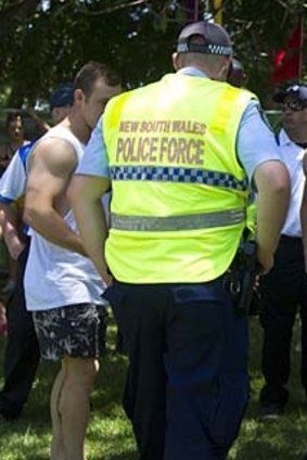 Police walk through the crowd at the Field Day music festival  held at The Domain.