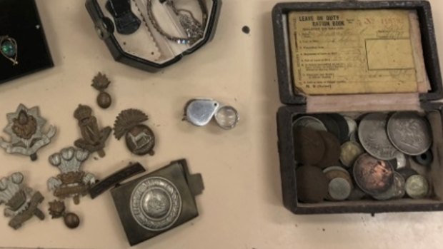 The ration book, coins and badges belonged to Lance Corporal Patrick Hannelly, 45th Battalion, WW1, who died in 1939.