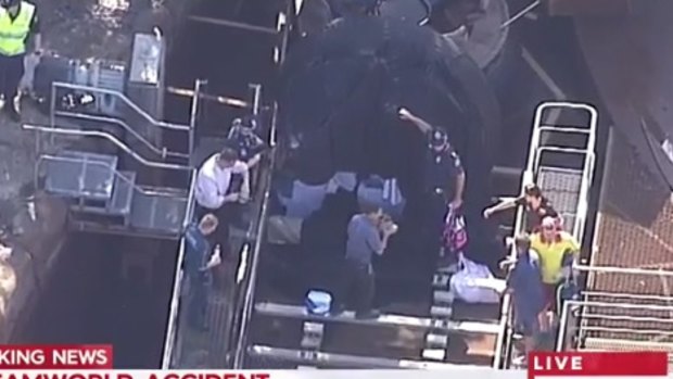Emergency services workers and police at the scene of the incident at Dreamworld. 