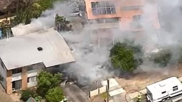 Firefighters battle a blaze at a home in Brisbane's west on Sunday.