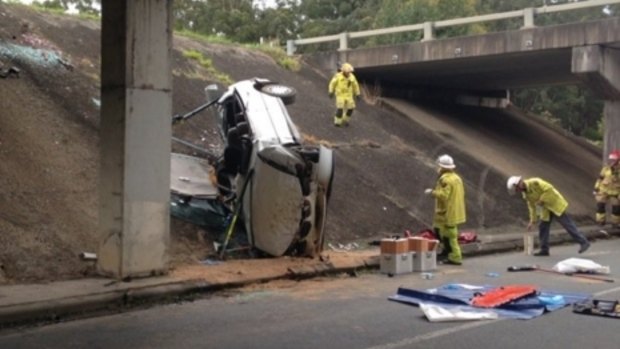 Emergency workers at the scene of a crash off the Bruce Highway at Palmview.