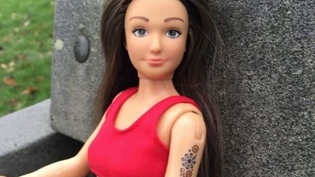 A Lammily doll with an arm tattoo. 
