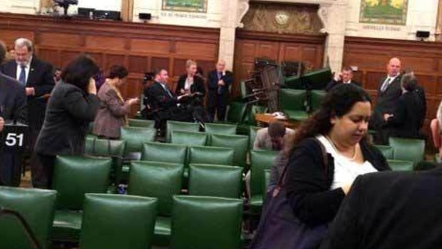 MPs block the door with chairs during a caucus meeting on Parliament Hill in Ottawa.