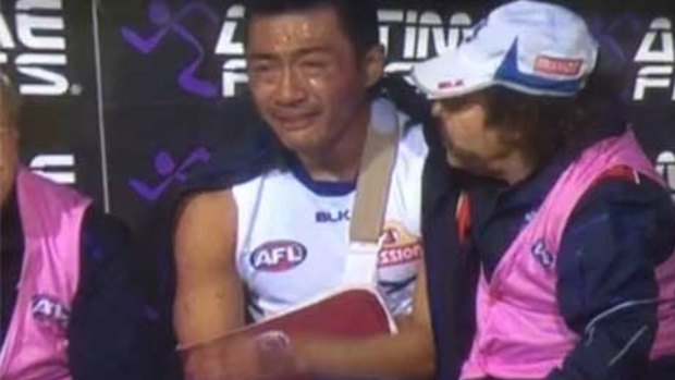 That was then: A devastated Lin Jong on the bench after breaking his collarbone.